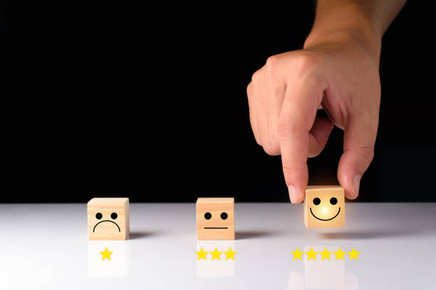istock Customer service and Satisfaction feedback concept ,Business people show feedback with smile face wood cube happy Smiley face icon satisfaction in service. wood cubes rating. wood cubes ideas. 1407649427