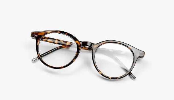 Photo of Stylish leopard-colored eyeglasses on a white background