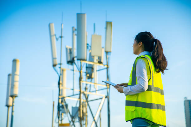 Engineer working at a telecommunications tower stock photo