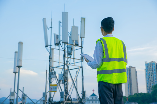 Engineer hand using digital tablet testing the communications tower