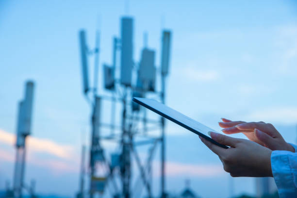 istock Human hand using digital tablet near 4G,5G communications tower 1407650748