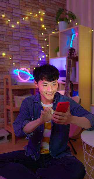 man use smartphone at night - east asian ethnicity japanese ethnicity asian ethnicity one person imagens e fotografias de stock