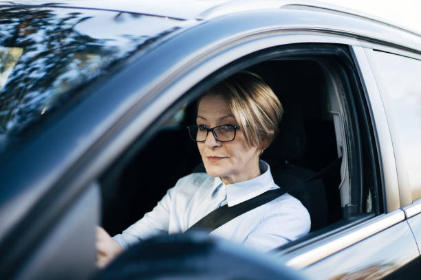 istock Mature woman driving a car. 1407651375