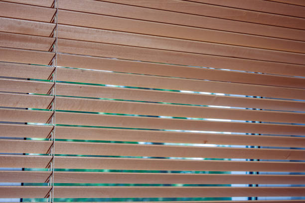 istock wooden blinds hang on the window 1407652549