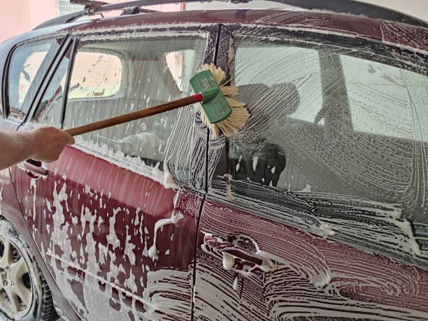 istock car wash, foam-drenched car is wiped with a brush 1407653788