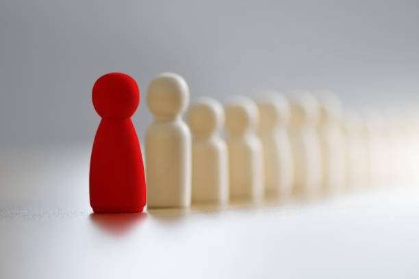 istock The red human figure extends its influence to the neighboring figures. 1407653987