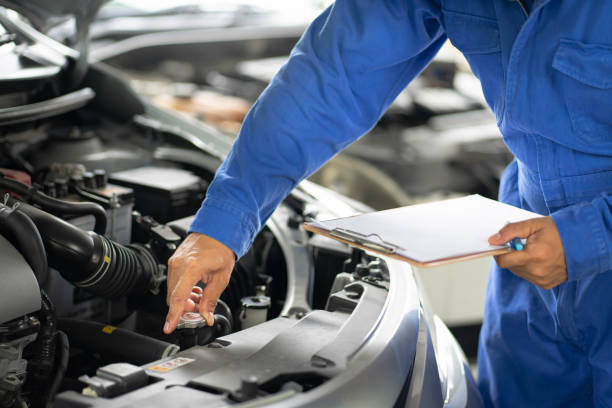 istock Mechanic checking the water cooling in car engine. 1407654683