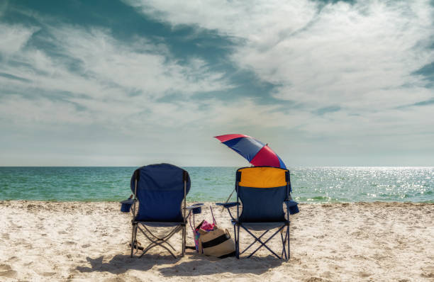 istock Sandy beach at sunset with lounge beach chairs. Vintage processed. 1407654719