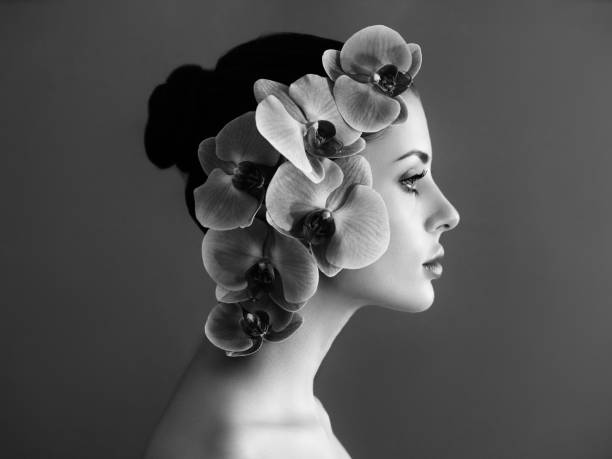 portrait of beautiful young woman with orchid - hairstyle black and white women fashion imagens e fotografias de stock