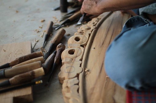 Cropped shot of hand carved wood on furniture components.