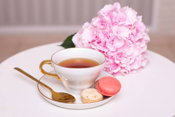 istock Cup of tea, macaroons and pink hydrangea 1407657465