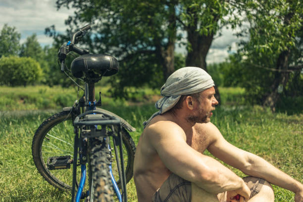 45 year old Man takes a break from his bike ride