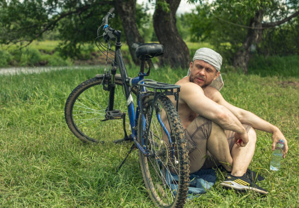 45 year old Man takes a break from his bike ride