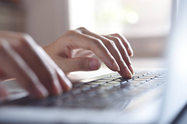 istock Business woman hands typing on laptop computer on office table with soft background, close up 1407660762