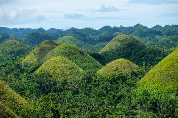 Chocolate Hills in Bohol, Philippines Bohol, Philippines - July 2022: The Chocolate Hills are a geological formation in Bohol Island on July 3, 2022 in Bohol, Philippines. chocolate hills photos stock pictures, royalty-free photos & images