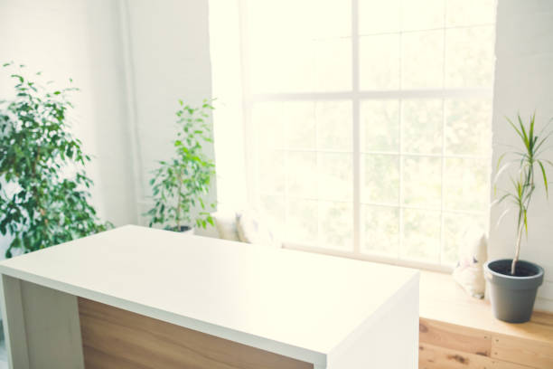 istock White table opposite the window in a bright room. 1407663076