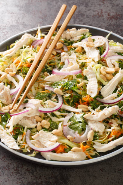 istock Authentic Vietnamese chicken salad Goi ga close-up in a plate. Vertical 1407663274