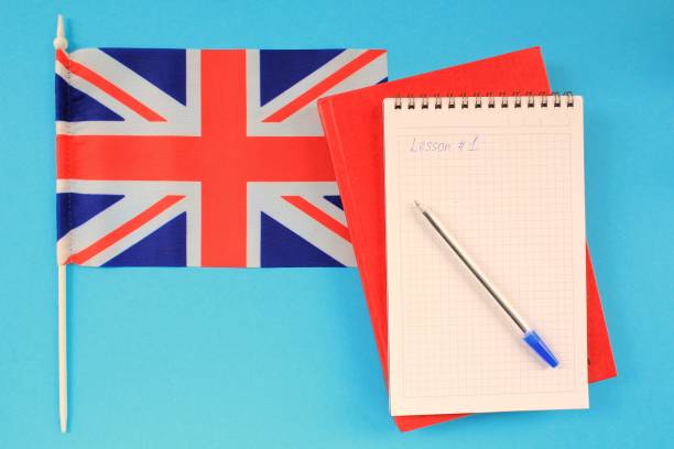 istock Flag of Great Britain, notebook and textbook on blue background 1407664104