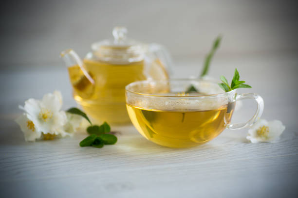 istock Composition with cup of jasmine tea and flowers 1407664578