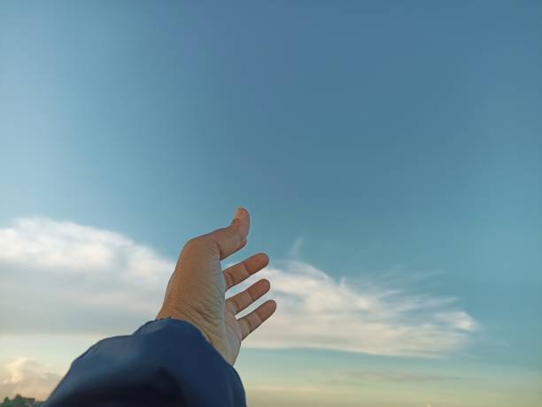 istock Hand reaching out to the sky. 1407665621