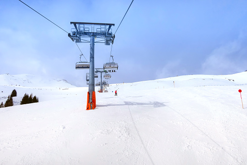 Ski chair lift and slope view in austrian resort Saalbach-Hinterglemm, Austria