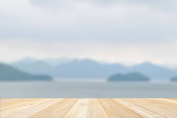 istock Empty top wooden table on nature view of lake blurred background 1407669814
