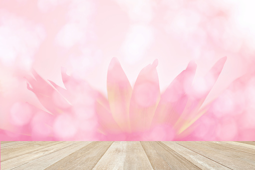 Wood table on soft blurred bokeh background with lotus flower pastel color