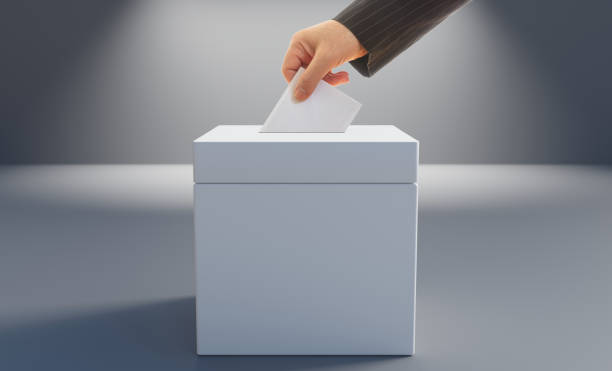istock Election concept. Voter putting an envelope in a blank white ballot box, space for text. 3d render 1407677966