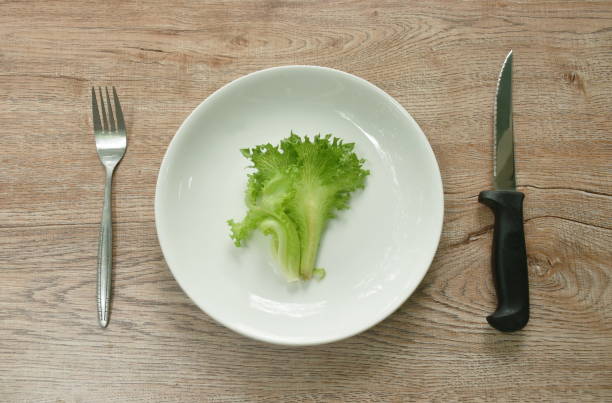 istock fresh lettuce with drop of water and fork couple knife 1407680849