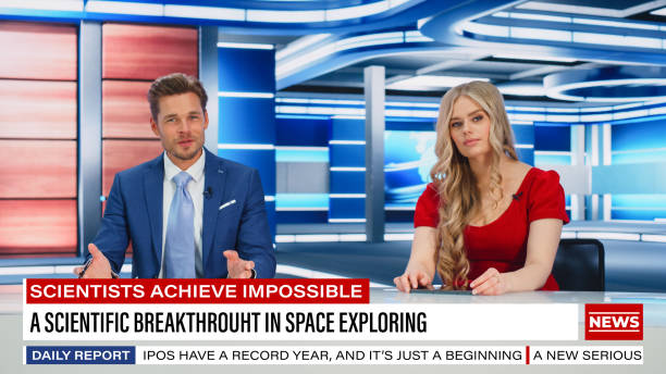 istock TV Live News Program: Two Presenters Reporting, Talking, Discuss Daily Events, Friendly Chat. Television Cable Channel Team of Male and Female Anchors Talk. Newsroom Studio Concept 1407680884