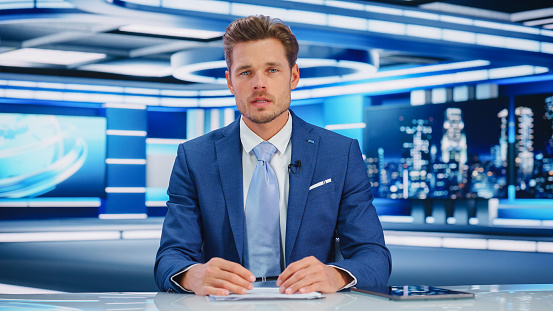 TV Live News Program: White Male Presenter Reporting On the Events, Science, Politics, Economy. Television Cable Channel Newsroom Studio: Anchorman Talks. Broadcasting Network with Mock-up