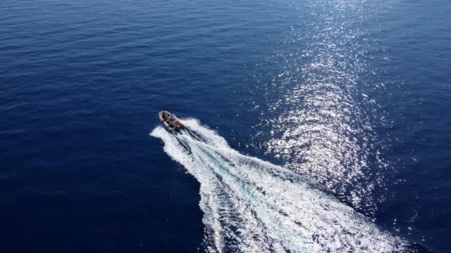 Aerial view of a inflatable motorboat in the sea.