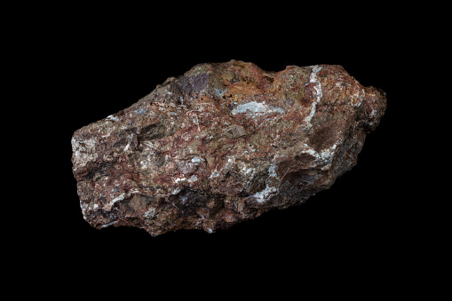 Chlorargyrite (silver ore) specimen, from the Purple Passion mine near Wickenburg, Arizona. Brown and orange with white quartz deposits. Photographed with black background.