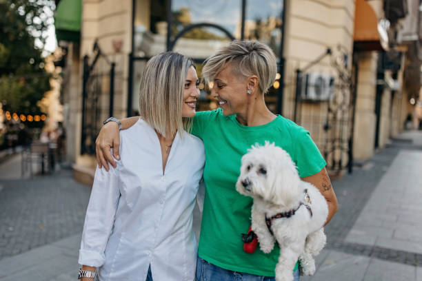 Female couple in love Smiling, loving couple, together with their pet. 2590 stock pictures, royalty-free photos & images