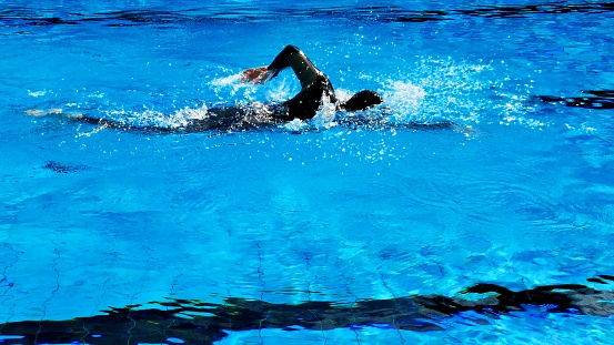 Shot from above of water polo player in dribble drive action