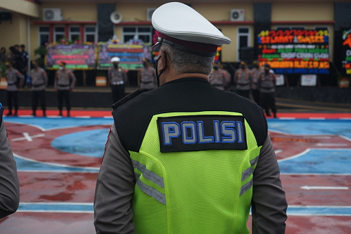 Sidrap, Indonesia - July 9 2022: Indonesian police personnel standing and lined up neatly during the ceremony. Seen personnel wearing clothes with police vests