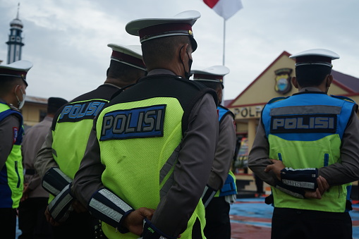 Sidrap, Indonesia - July 9 2022: Indonesian police personnel standing and lined up neatly during the ceremony. Seen personnel wearing clothes with police vests
