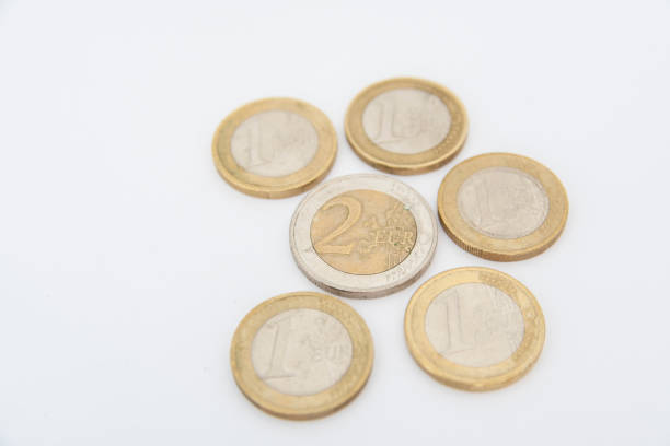 istock Euro coins lying on a white background 1407700329