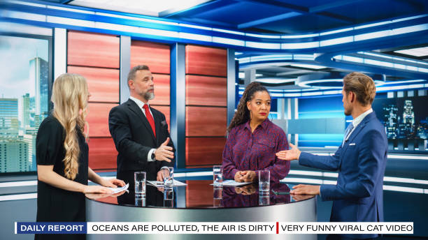 istock Talk Show TV Program: Four Diverse Specialists, Experts, Guests, Presenter, Host Discuss and Argue about Politics, Economy, Science, News. Mock-up Television Cable Channel Studio Debate 1407701903