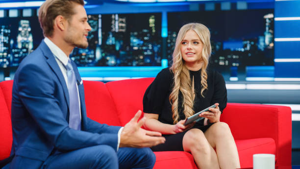 istock Talk Show TV Program, News Interview and Discussion: Presenter and Guest Talk. Cable Channel Hosts Have Friendly Conversation. Mock-up Television Studio and Newsroom Entertainment Concept 1407702491