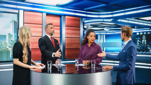 istock Talk Show TV Program: Four Diverse Specialists, Experts, Guests, Presenter, Host Discuss and Argue about Politics, Economy, Science, News. Mock-up Television Cable Channel Studio Debate 1407702538