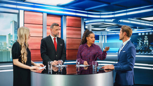 istock Talk Show TV Program: Four Diverse Specialists, Experts, Guests, Presenter, Host Discuss and Argue about Politics, Economy, Science, News. Mock-up Television Cable Channel Studio Debate 1407702548