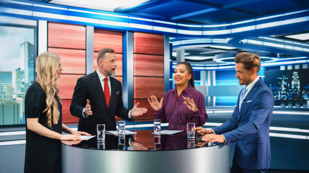 istock Talk Show TV Program: Four Diverse Specialists, Experts, Guests, Presenter, Host Discuss and Argue about Politics, Economy, Science, News. Mock-up Television Cable Channel Studio Debate 1407702555
