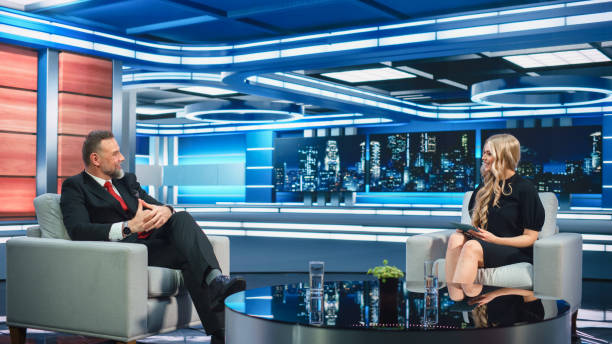 istock Talk Show TV Program Presenter and Celebrity Interview. Host and Guest Discuss Politics, Economy, Science, News, Entertainment. Mock-up of Cable Channel Studio. Wide Shot, Television Concept 1407702860