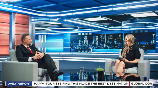 istock Talk Show TV Program Presenter and Celebrity Interview. Host and Guest Discuss Politics, Economy, Science, News, Entertainment. Mock-up of Cable Channel Studio. Wide Shot, Television Concept 1407702866