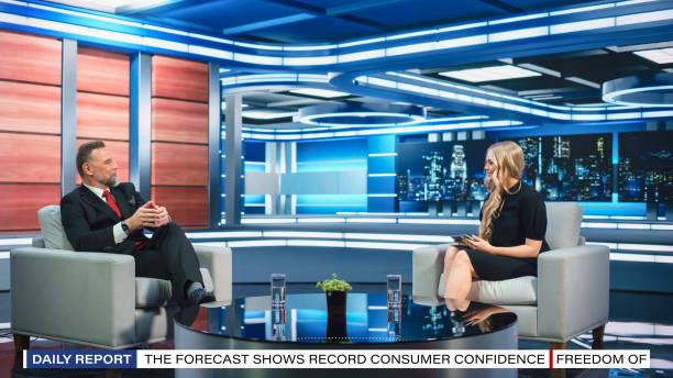 istock Talk Show TV Program Presenter and Celebrity Interview. Host and Guest Discuss Politics, Economy, Science, News, Entertainment. Mock-up of Cable Channel Studio. Wide Shot, Television Concept 1407702879