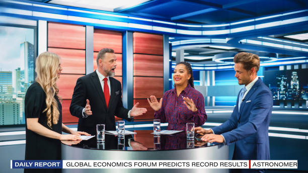istock Talk Show TV Program: Four Diverse Specialists, Experts, Guests, Presenter, Host Discuss and Argue about Politics, Economy, Science, News. Mock-up Television Cable Channel Studio Debate 1407703027