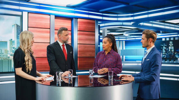 istock Talk Show TV Program: Four Diverse Specialists, Experts, Guests, Presenter, Host Discuss and Argue about Politics, Economy, Science, News. Mock-up Television Cable Channel Studio Debate 1407703051
