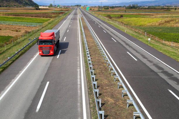 istock Truck driving on a highway 1407703752