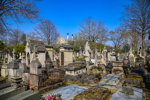 Calgary, Alberta, Canada â October 9, 2022: Tombstones in a Chinese graveyard on the hill in Calgary with a blue sky in the background